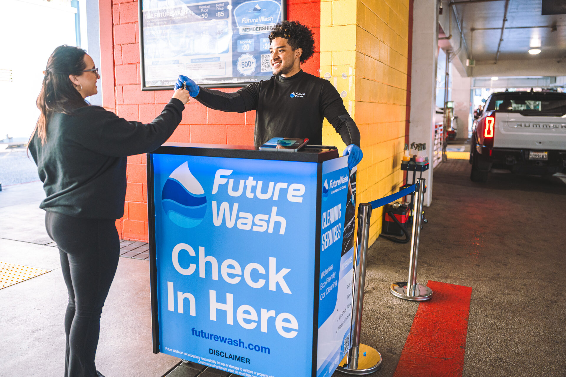 Future Wash technician checking in a customer vehicle