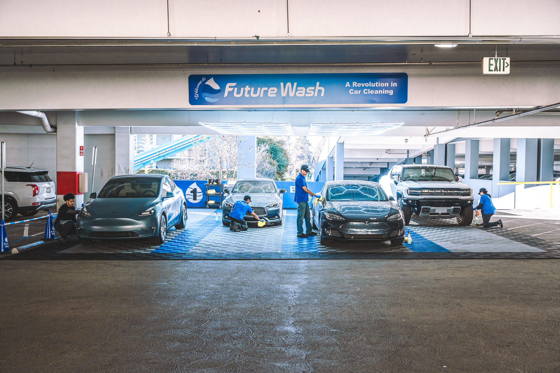Wide view of the Future Wash retail bay showing the checkered floor and hex LED lighting